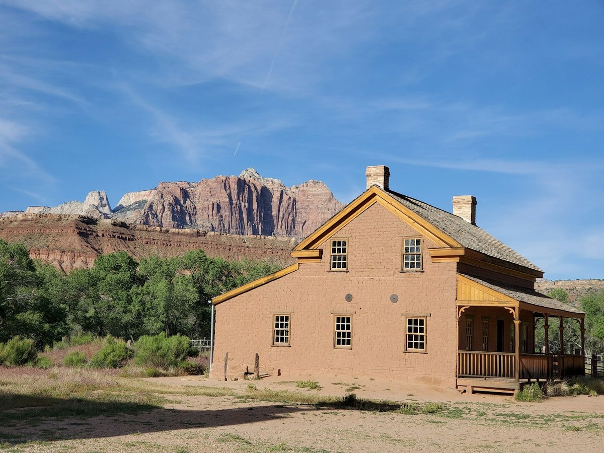 Historic brown building near pink cliffs in Grafton, Utah, for local place context